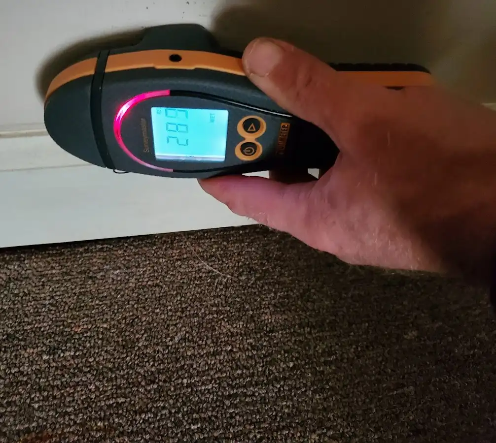 Moisture detection at baseboard during Storm Damage Restoration in Astoria